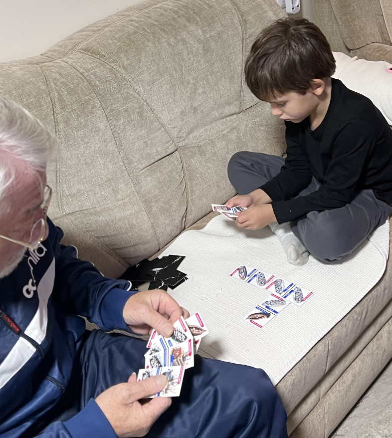Tyler playing the Maritime Domino Game with family